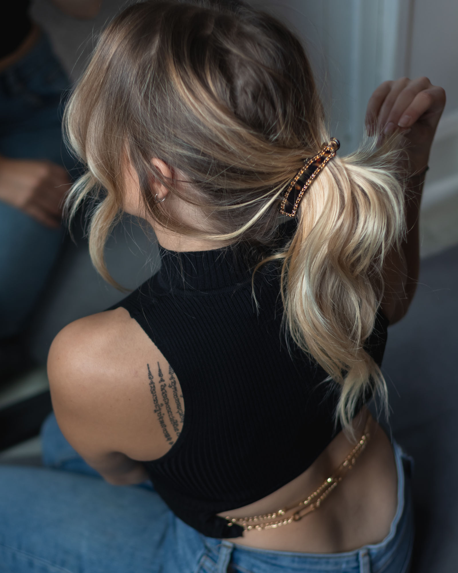 Soft low ponytail with a barrette, chic trendy hairstyle