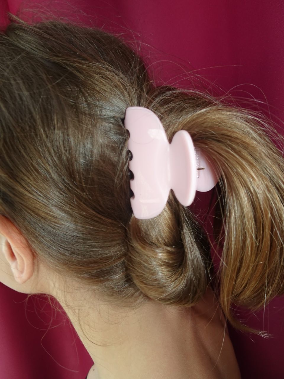 Twisted low ponytail with pastel clip, trendy hairstyle