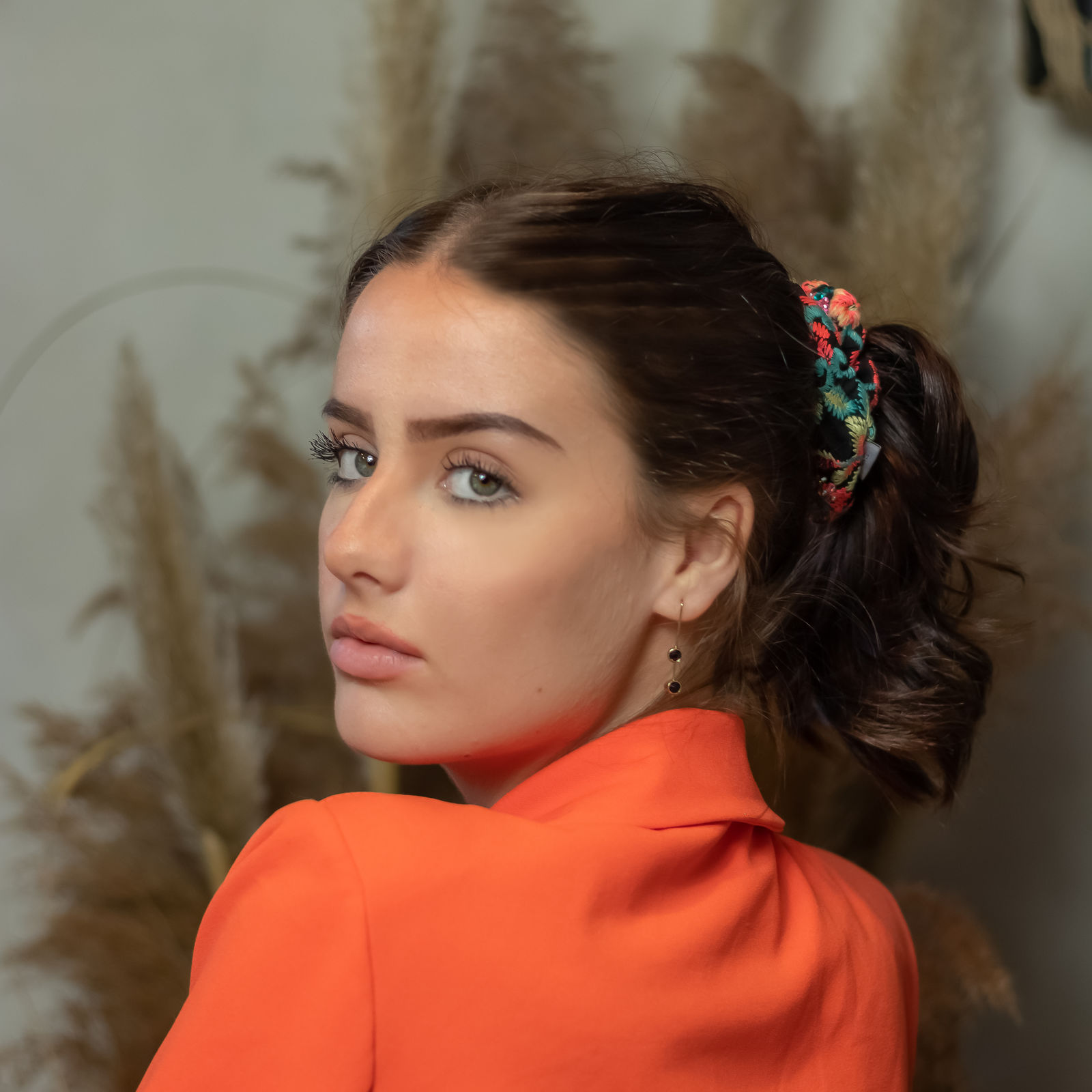 Sleek high ponytail with scrunchie, runway look